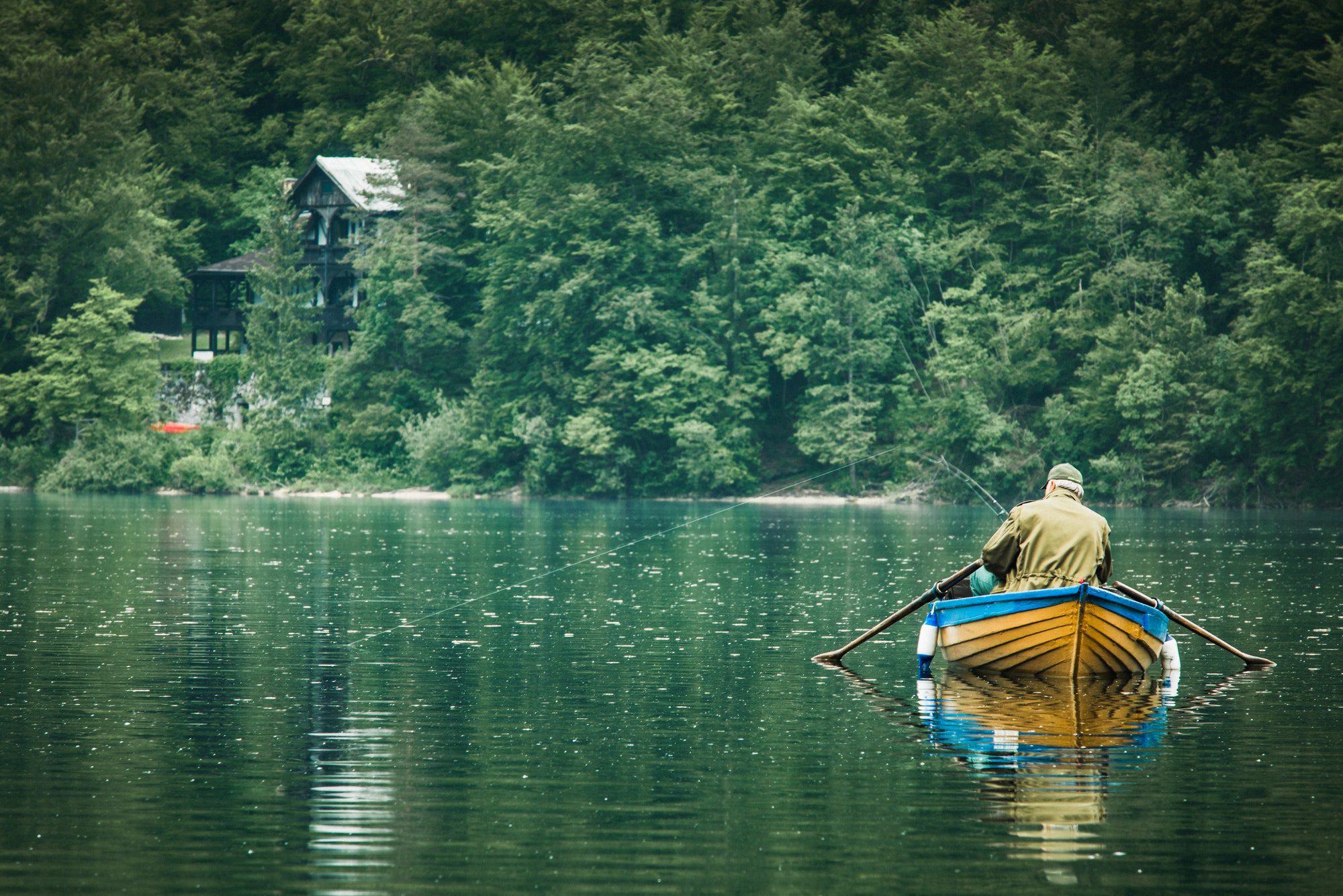 A retiree fishing from a boat at the lake in San Antonio, Texas.